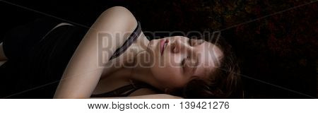 Woman lying on her side against dark background-Proportionate to Large Mobile Banner