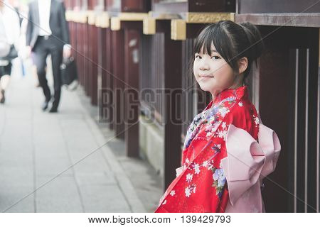 Beautiful Asian girl wearing red kimono walking in the cityAsakusa Tokyo Japan.