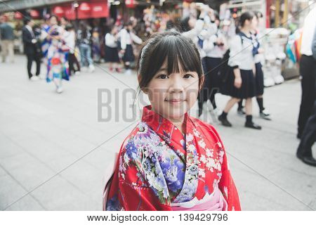 Beautiful Asian girl wearing red kimono walking in the cityAsakusa Tokyo Japan.