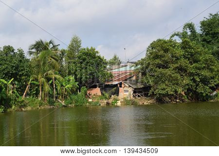 Vietnamese countryside with house next to the fishing pond