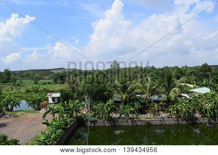 Vietnamese countryside with house next to the fishing pond