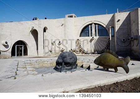 YEREVAN ARMENIA - March 8 2015: Modern art statues human face and fish near Yerevan Cascade giant stairway in Yerevan, Armenia. It's important city landmark completed in 1980