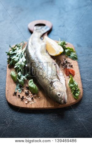 Raw troutfish on the wooden board,selective focus