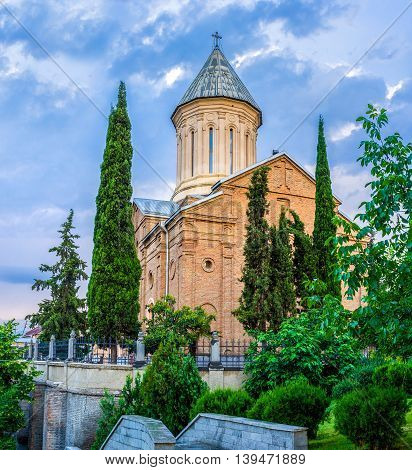 The Ejmiatsin Church of Armenian Apostolic church surrounded by sypresses located in Avlabari District Tbilisi Georgia.