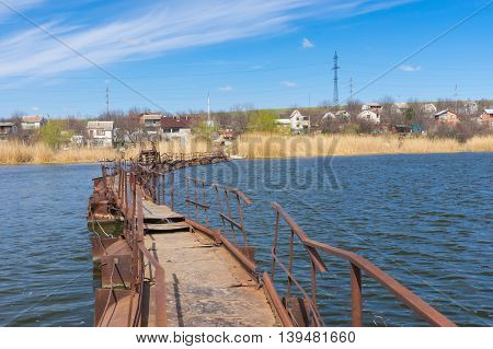 Pontoon bridge over small river to remote Ukrainian village
