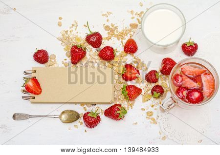 Blank notebook with craft brown pages ripe strawberries and oat muesli for breakfast