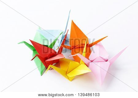 colorful paper origami birds on a white background