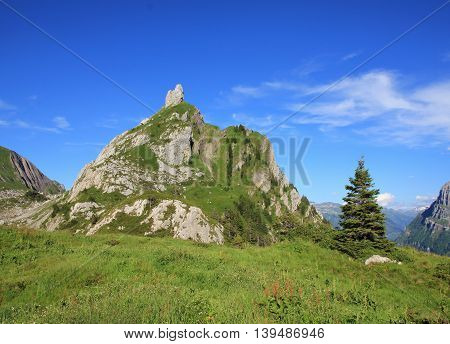 Mountain in Glarus Canton. Mt Dejenstogg in summer. Scene on a hiking route towards lake Klontalersee.