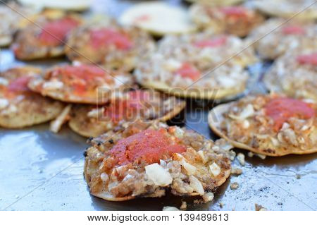 Mini tostadas with toppings of meats and veggies - traditional street food at local markets in Quetzaltenango Guatemala. Shallow depth of field