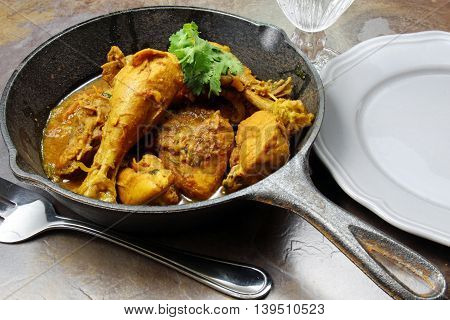 North Indian spicy chicken curry in a skillet