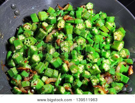 Okra or Bhindi fry an Indian stir fry made of onions and red chili pepper.