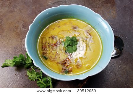 Yellow Lentil soup or Arhar Daal fry with the tadka of cumin seeds garlic and green chilies on a moody background