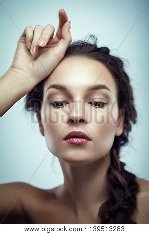 Fashion portrait of gorgeous young brunetee woman.Chaos hair style with braid. Shallow depth of field