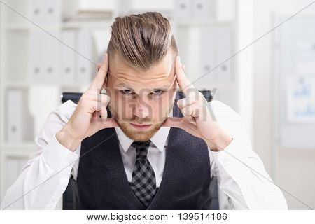 Young Businessman Thinking Looking At Camera
