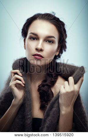 Fashion portrait of gorgeous young brunetee woman.Chaos hair style with braid. Shallow depth of field