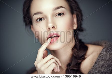 Fashion portrait of gorgeous young brunetee woman.Flirt expression. Shallow depth of field