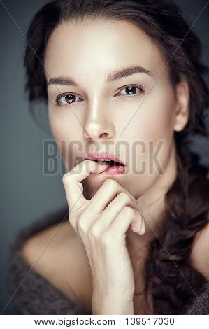 Fashion portrait of gorgeous young brunetee woman.Flirt expression. Shallow depth of field