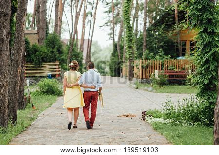 Lovers Hold Hands And Walk In The Park