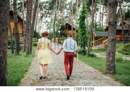Lovers Hold Hands And Walk In The Park