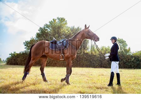 Beautiful Jockey Girl Stand Next To Her Horse.