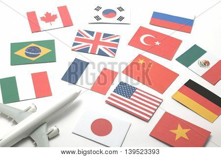 Travel by airplane.
Miniature airplane go toward  national flags of many countries.