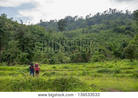 Man Traveler with big backpack mountaineering Travel to the Pre To Lo Su or Pi Tu Kro waterfall heart-shaped waterfall Umphang Tak ,Thailand.