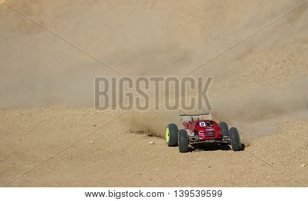 BOISE IDAHO-JULY 16 2016: Long truggy kicking up a lot of dirt power through the straight at the Boise Summer Blase Rc race