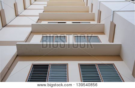 Look up at apartment housing in Thailand. Step of building.