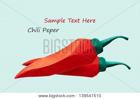 Origami paper red chili pepper hot on a blue background