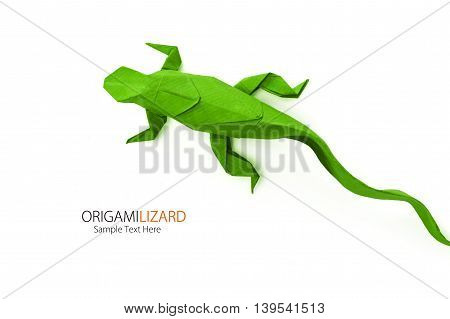 Origami paper art green wild lizard on a white background