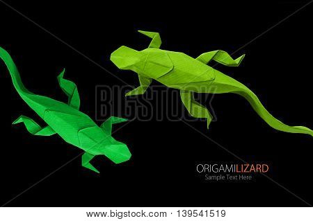 Origami paper art green wild lizards on a black background