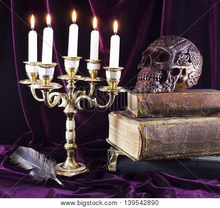 Mystic still life with candelabrum, skull and old book