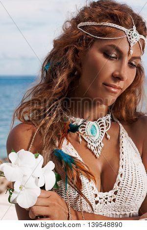 young bride in white dress on beach