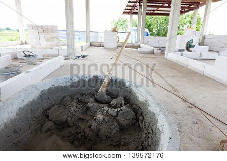 building construction wall. mix cement plaster concrete in bucket