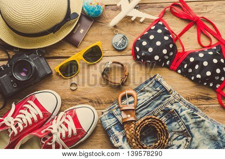 Beauty colorful bikini and accessories on wooden floor