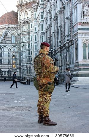 FLORENCE, Italy - January 19, 2016: cathedral Santa Maria del Fiore (Duomo) and soldier of special unit of the italian army  for the operation safe roads as prevention against terrorist attacks on January 19, 2016 Florence, Tuscany, Italy