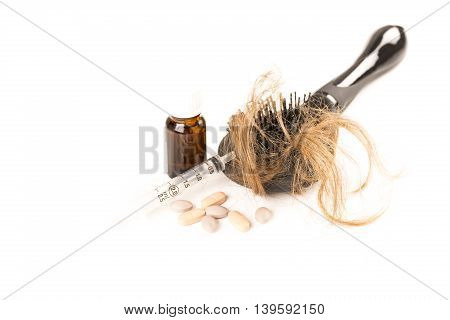 Close-up of hair loss, long hair, alopecia treatment on white background with brush