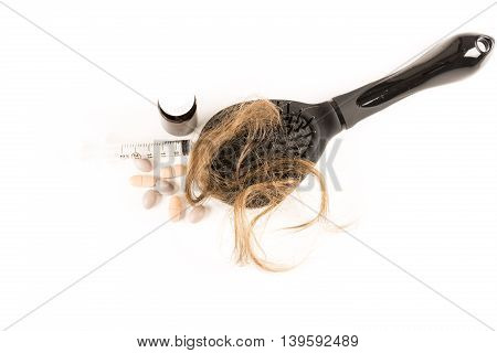 Close-up of hair loss, long hair, alopecia treatment on white background with brush