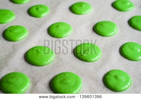 raw a makarons on a baking sheet.