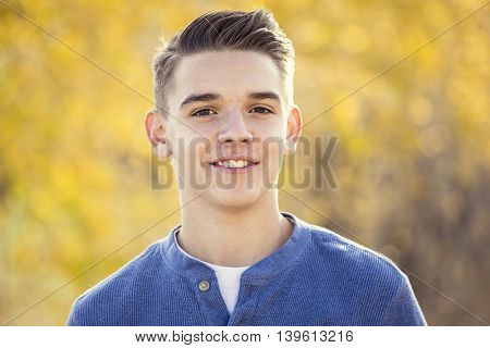 Portrait of smiling teen boy outdoors. Boy looking at the camera with a handsome smile on his face