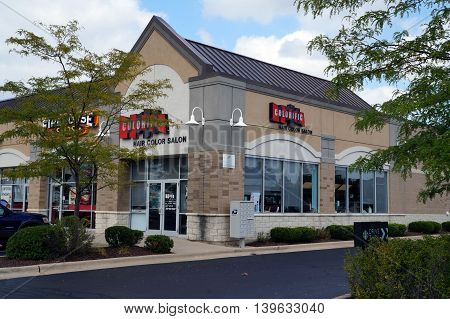 JOLIET, ILLINOIS / UNITED STATES - AUGUST 30, 2015: One may have one's hair colored at the Colorific Hair Salon, in a Joliet strip mall.