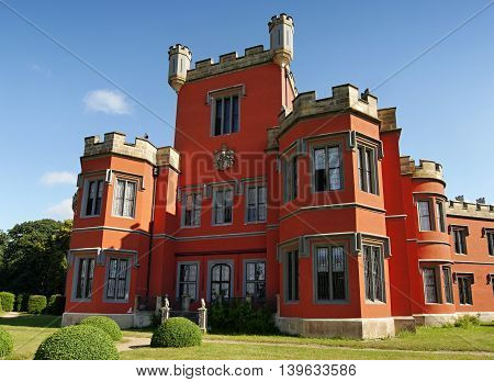 Romantic castle with red facade. Hradek u Nechanic. Czech Republic. Nechanice. July 7, 2016