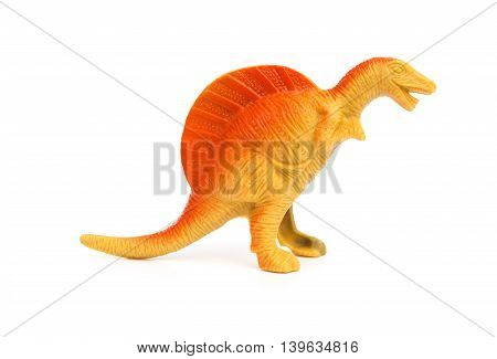 side view orange spinosaurus toy on a white background