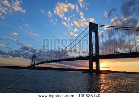NEW YORK - JULY 23, 2016: Verrazano Bridge at sunset in New York .The Verrazano Bridge is a double-decked suspension bridge that connects the boroughs of Staten Island and Brooklyn