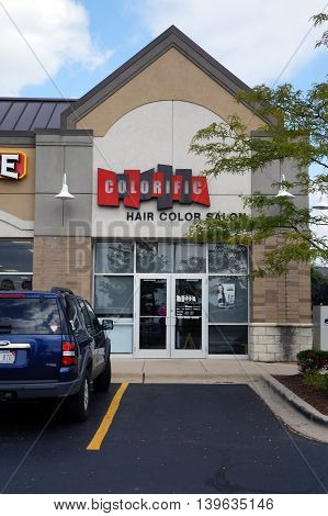 JOLIET, ILLINOIS / UNITED STATES - AUGUST 30, 2015: One may have one's hair colored at the Colorific Hair Salon, in a Joliet strip mall.