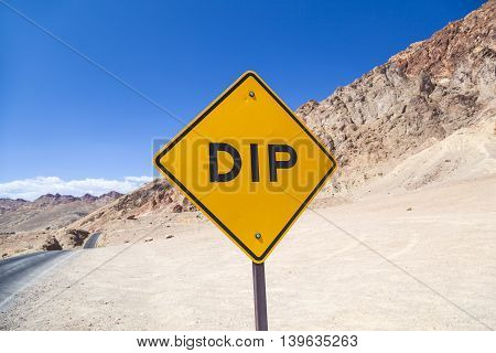 scenic road Artists Drive in Death valley with colorful stones hills with minerals road sign DIP for hilly road