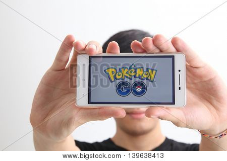 Kuala Lumpur,Malaysia 23th July 2016,teenager holding a smartphone with pokemon go logo on the screen