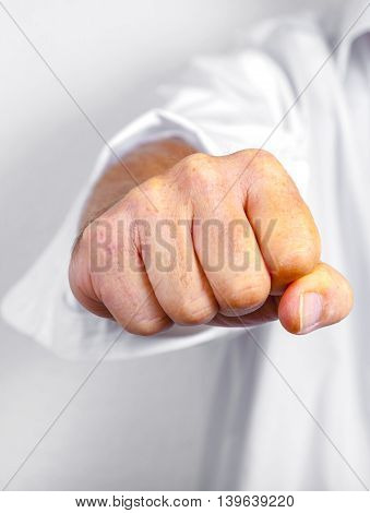 detail of male fist in white business shirt