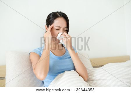 Woman suffer form headahce and runny nose