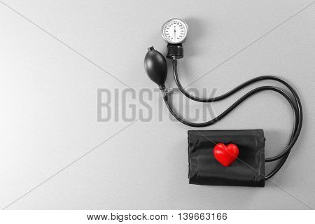 Tonometer with red heart on grey table